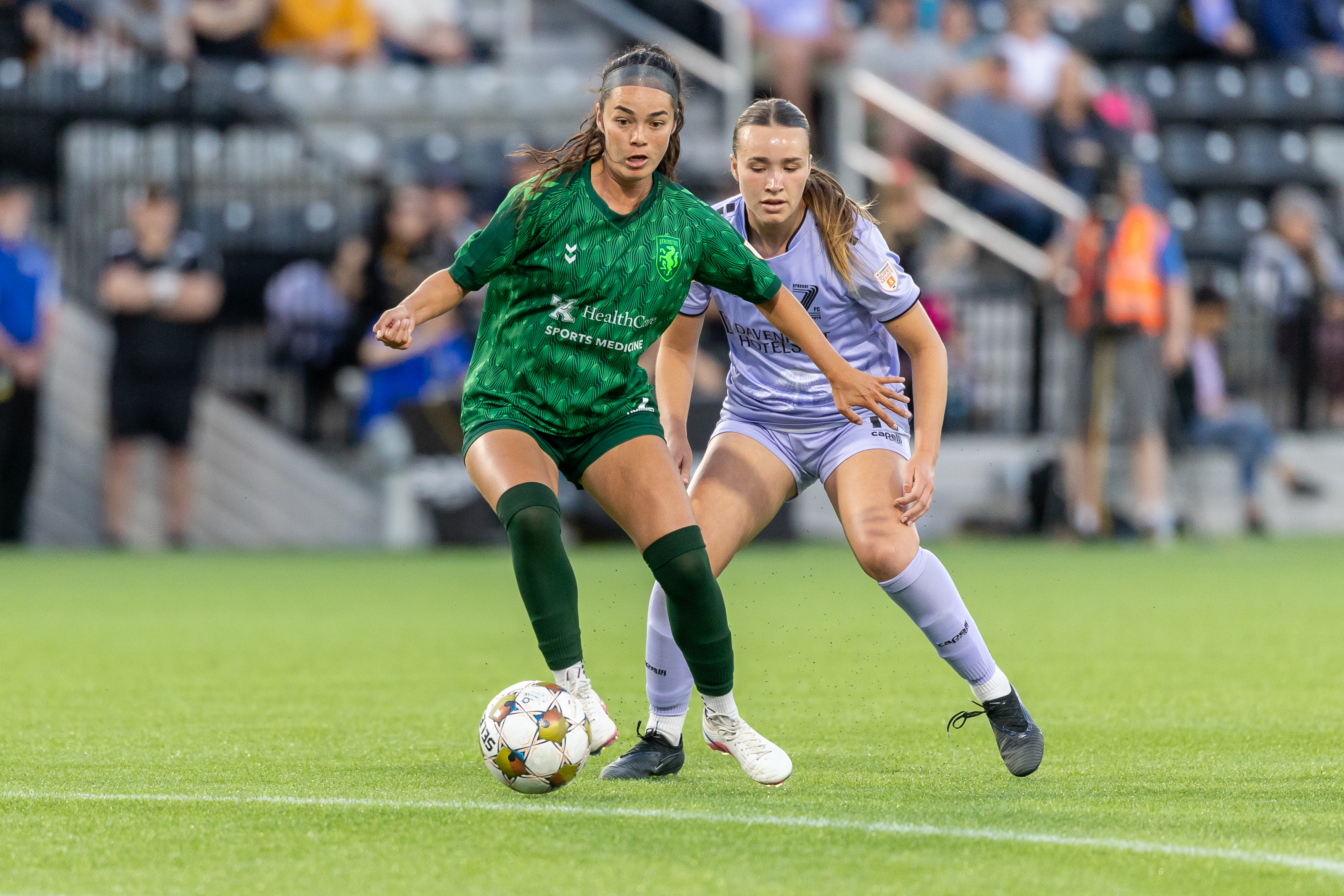 LSC player on the ball against an opponent